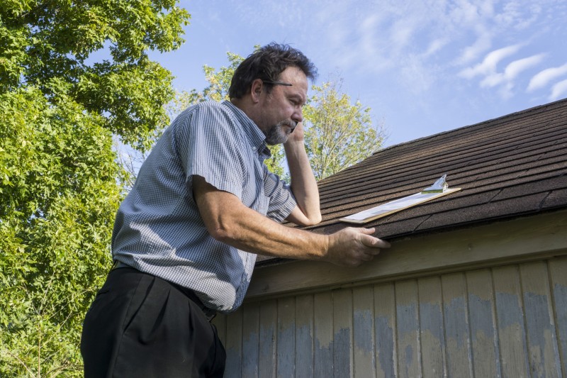 Insurance Adjuster doing roof inspection